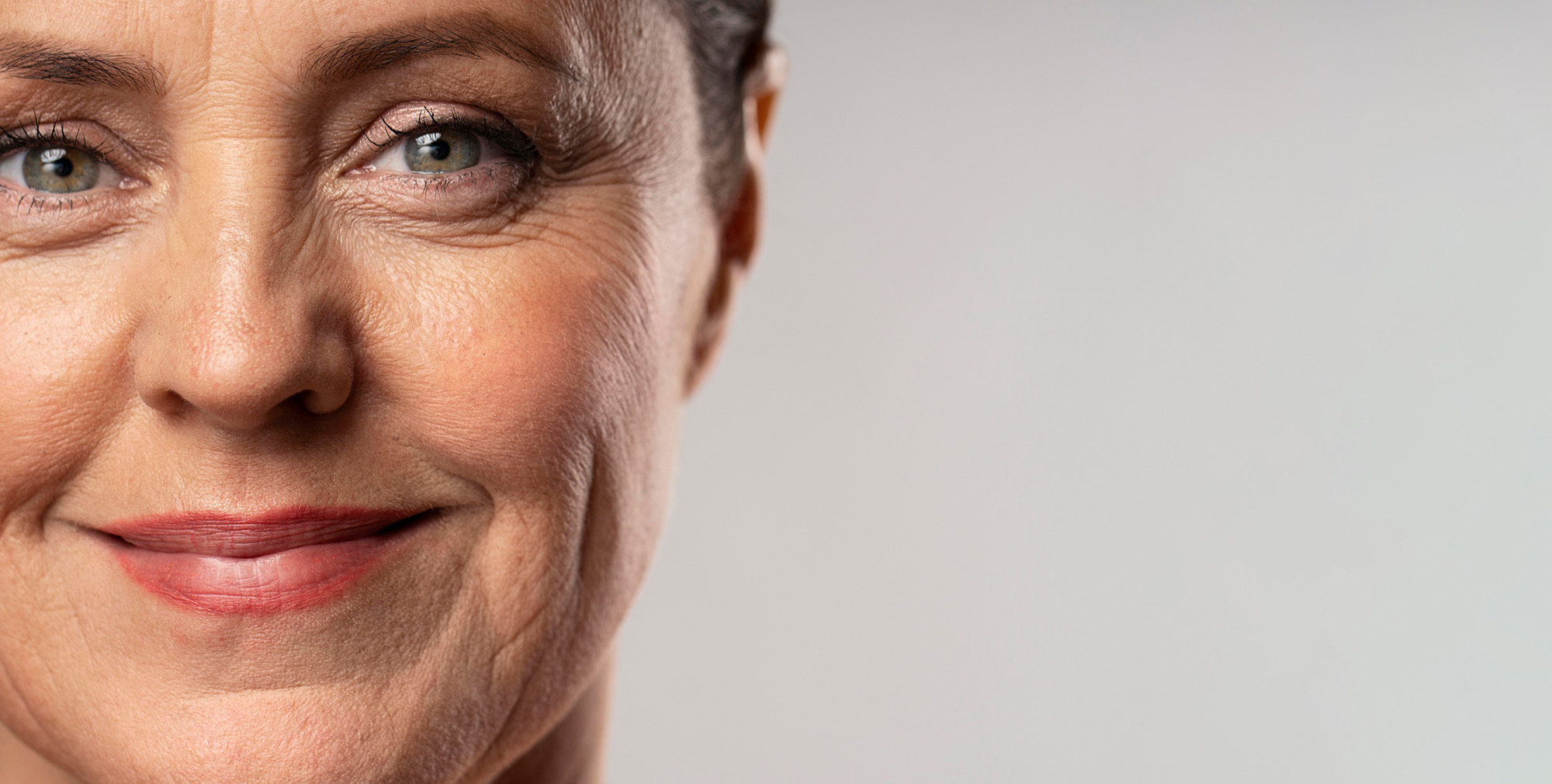 front-view-smiley-elder-woman-posing-with-make-up